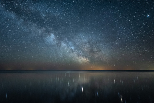 The Milky Way reflected on a calm lake.