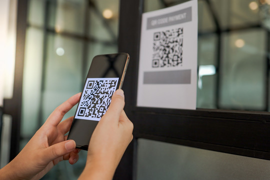 A person scanning a QR code with their phone