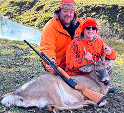 Adult and youth with a deer the youth harvested