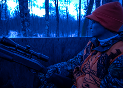 a hunter in an early morning deer stand during firearms season