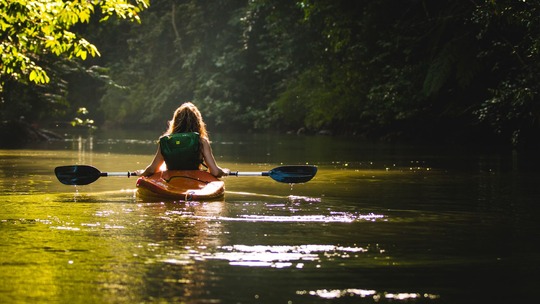 A person kayaking on a river