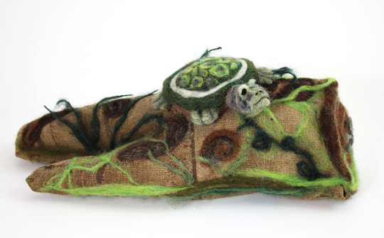Felt sculpture, in green and brown colors.