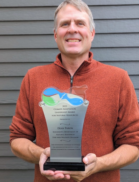 A man holding an award