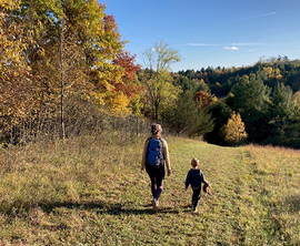 adult and child hiking in a state park