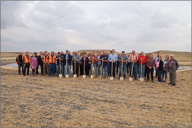 Participants at the groundbreaking ceremony on the Mustinka River. 