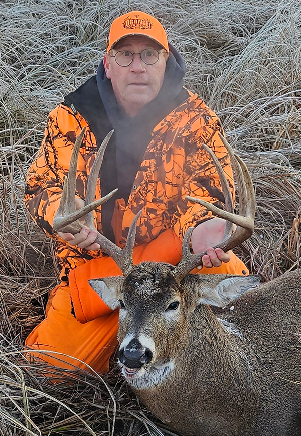 man with deer he harvested