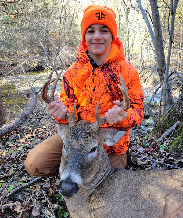 youth hunter with deer he harvested