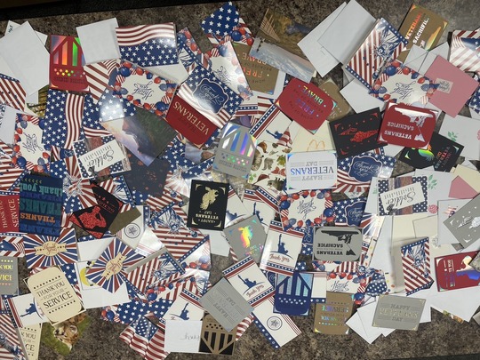 A pile of Veterans Day cards spread out on a table