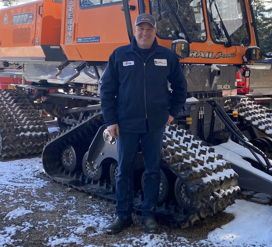 A man standing in front of construction equipment