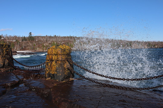 Water splashes near a scenic vista at a state park, icicles forming on a chain