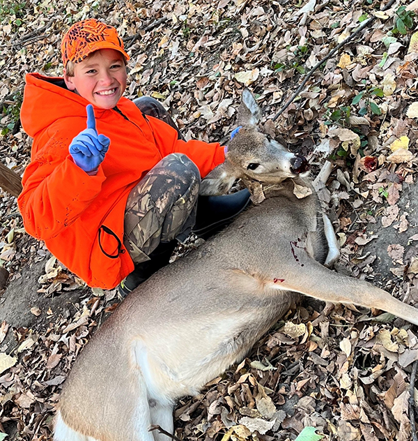 youth hunter with deer harvested