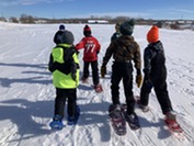 Group of children snowshoeing on open field