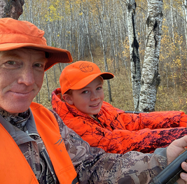 adult and youth in the tree stand during a deer hunt