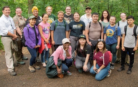 A group of people in a verdant forest