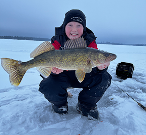 young angler with a walleye he caught