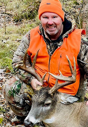 hunter with deer harvested during firearms season