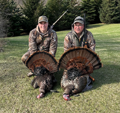 two turkey hunters with turkeys they harvested