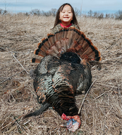 a young turkey hunter with a bird harvested