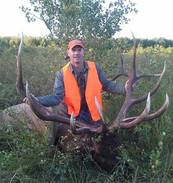 elk hunter with bull elk he harvested