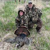 adult turkey hunter with youth turkey hunter and a turkey