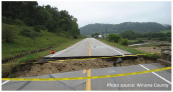 road with washed out area and safety tape showing road is closed