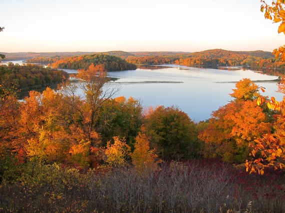 A stunning overlook of prairie and vibrant red and gold trees. 