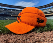 Twins cap, blaze orange, on the grass