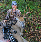 crossbow hunter with big buck and crossbow