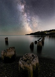 The Milky Way shines brightly in the sky above Lake Superior. 