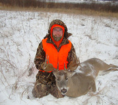 hunter with deer he harvested