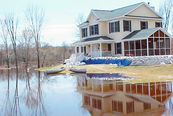 Elevated house surrounded by floodwaters