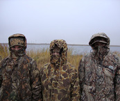 three girls in full camo with only their eyes showing