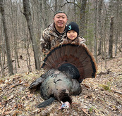 young spring turkey hunter and adult with bird harvested