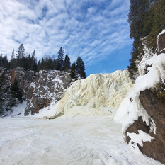 A frozen waterfall on a blue sky day. 