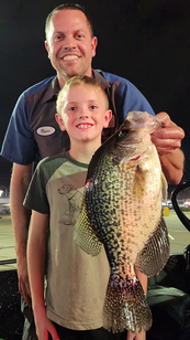 angler and adult with the record crappie