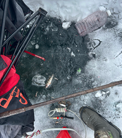 a bunch of litter on and frozen into the ice