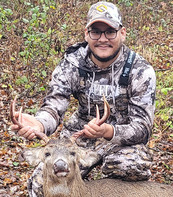 hunter with buck he harvested