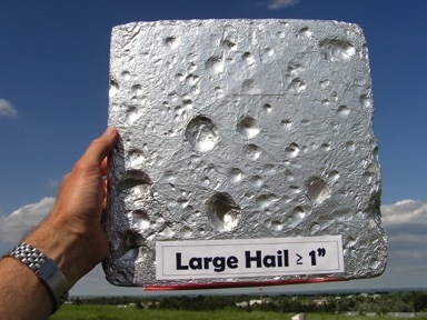 Styrofoam square with dents from hail hitting it