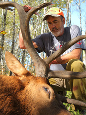 photo of a hunter with an elk he harvested