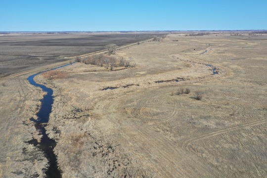 Drone photo of stream channel straightened by ditching
