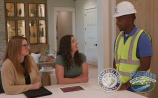 Flood Man Dan talking with two women in a home
