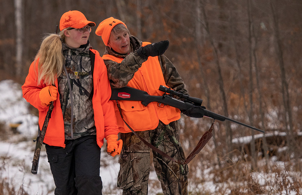 two women hunting with blaze orange on