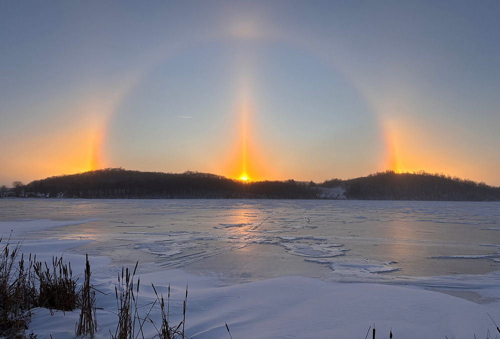 big sun dog over a frozen lake in a state park