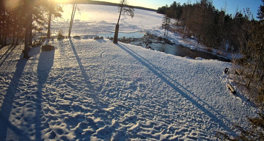 The sun rises over a snowy lake at the headwaters of the Mississippi River. 