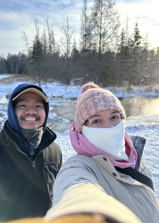 Two people take a selfie a the Headwater of the Mississippi on a very cold, snowy day.