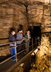 Two teens take a cave tour with a naturalist.