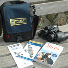 A state park birding kit that includes binoculars, bird guides, and bird checklist. 