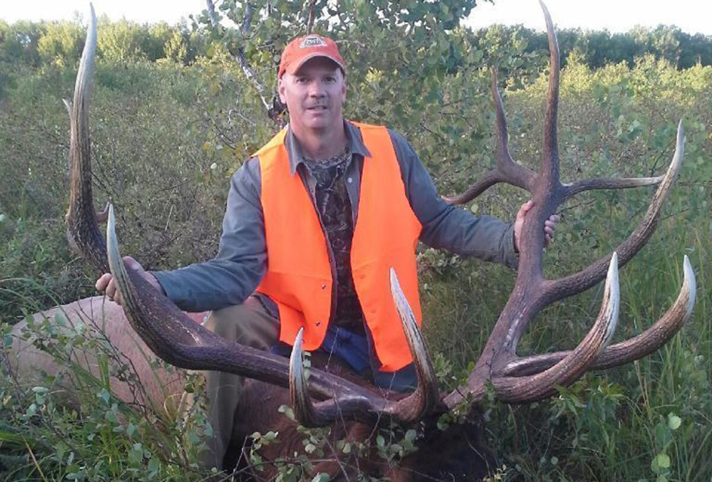 hunter with his record bull elk