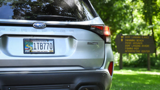 A parked vehicle displays a Minnesota state parks and trails license plate.