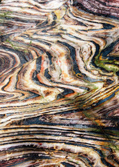Close up look at red, white, and black striped rock.